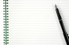 An Open Spiral Notepad With Blank Lined Paper And