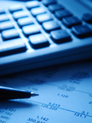 financial statement with calculator and pen