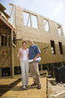 © iofoto - Man and woman on construction site.