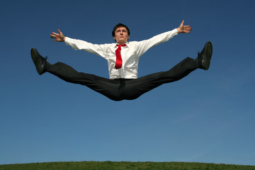 Wall Mural - businessman doing splits in mid-air