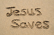 jesus saves, written on a sandy beach.