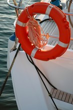 Orange Lifebuoy Hanging On The Back Of The Boat