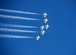 team of fighter jets flying in formation