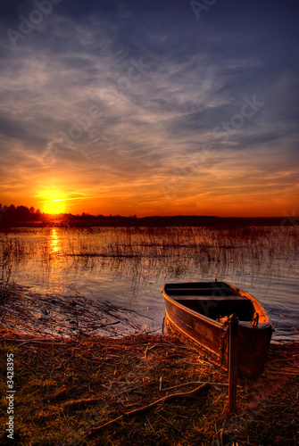 Naklejka - mata magnetyczna na lodówkę a boat by the lake at sunset