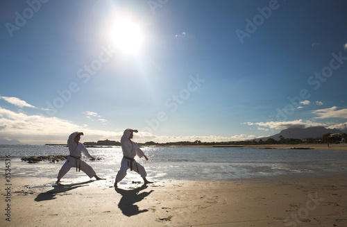 Obraz w ramie Man practicing Karate on the beach