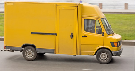 Wall Mural - Yellow truck on asphalt road