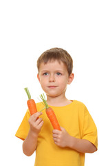 Wall Mural - five years old boy eating fresh carrot isolated on white