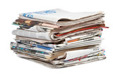 Fototapeta  - A stack of local newspapers with focus on front. Shallow DOF