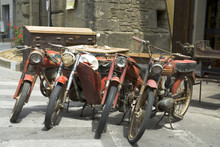 Old Mopeds In Front Of A Vintage Store