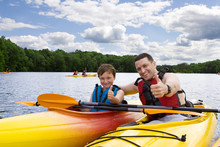 Father And Son Enjoying Kayaking