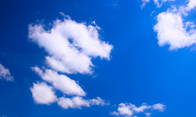 Wall Mural - white clouds against a deep blue sky