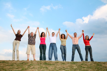 group of people with hands up