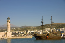 Chania Harbor In Crete, Greece With Lighthouse Schooner