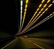 Cars On Road In Tunnel With Lights Overhead