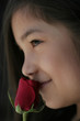 Young girl with red rose