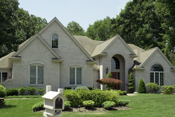 Wall Mural - Beautiful beige brick home with nice landscaping.