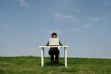 Businessman sitting at desk, outdoors