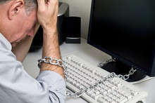 A Man Feeling As If He Is Chained To His Computer 