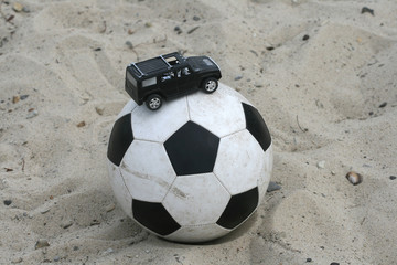 Toy black jeep on a football 