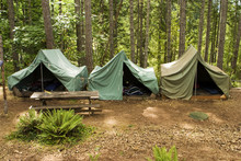 A Group Of Canvas Tents At A Campground At Summer Camp.