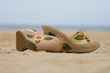 Female footwear forgotten on a beach