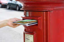 Posting Many Letters To Red British Postbox On Street