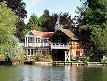 Riverside Dwelling And Boathouse On The Thames In England