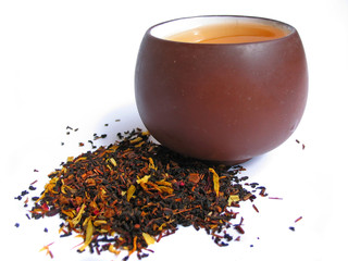 Wall Mural - A mix black and flower tea leaves with cup of tea