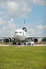 Poster - DC-10 jet with missing engines towed for dismantling