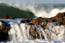 Large Ocean Waves Crashing Over Rocks At The Sea Side