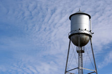 Water Tower On A Cloudy Sky