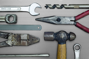 Closeup of some work tools on metal surface