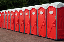 Row Of Red Portable Toilets