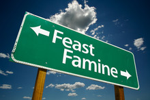 “Feast Or Famine” Road Sign With Dramatic Clouds And Sky