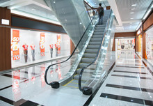 Persons on escalator in shop
