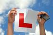 Key to success - woman holding L plate with key