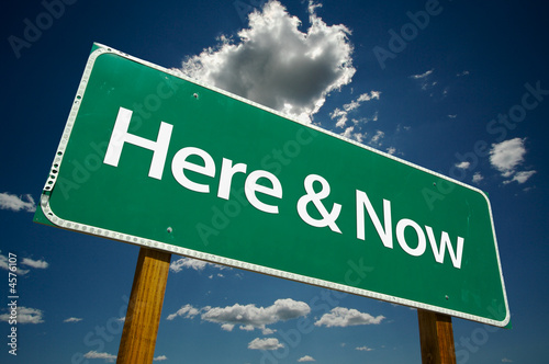 Fotografía "Here & Now" Road Sign with dramatic clouds and sky.