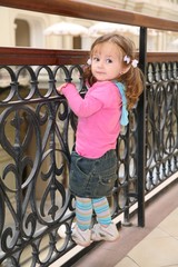 little girl on forged railings