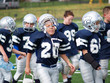 young football players walking on sideline
