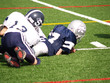 young football player being tackled