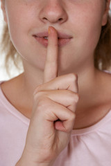  Woman holding finger to lips