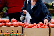 Woman Shopping For Fresh Produce At Local Farmer's Market