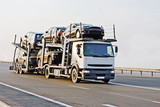 Fototapeta Zachód słońca - car carrier truck deliver batch to dealer 