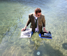 A Young Dj Plays Music In The Sea