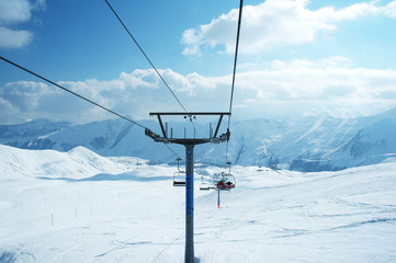 Ski lift chairs on bright winter day