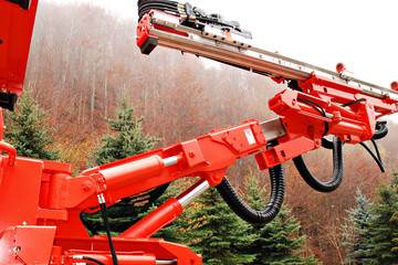 orange heavy duty mine drill in wood