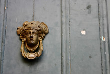 Old Door Knocker On Old Painted Wall.
