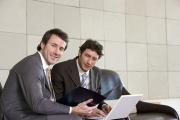 two businessmen with laptop