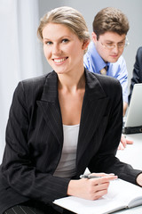 Poster - Portrait of smart woman sitting at the table