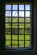 An Old Medieval Window With Bars In A Castle